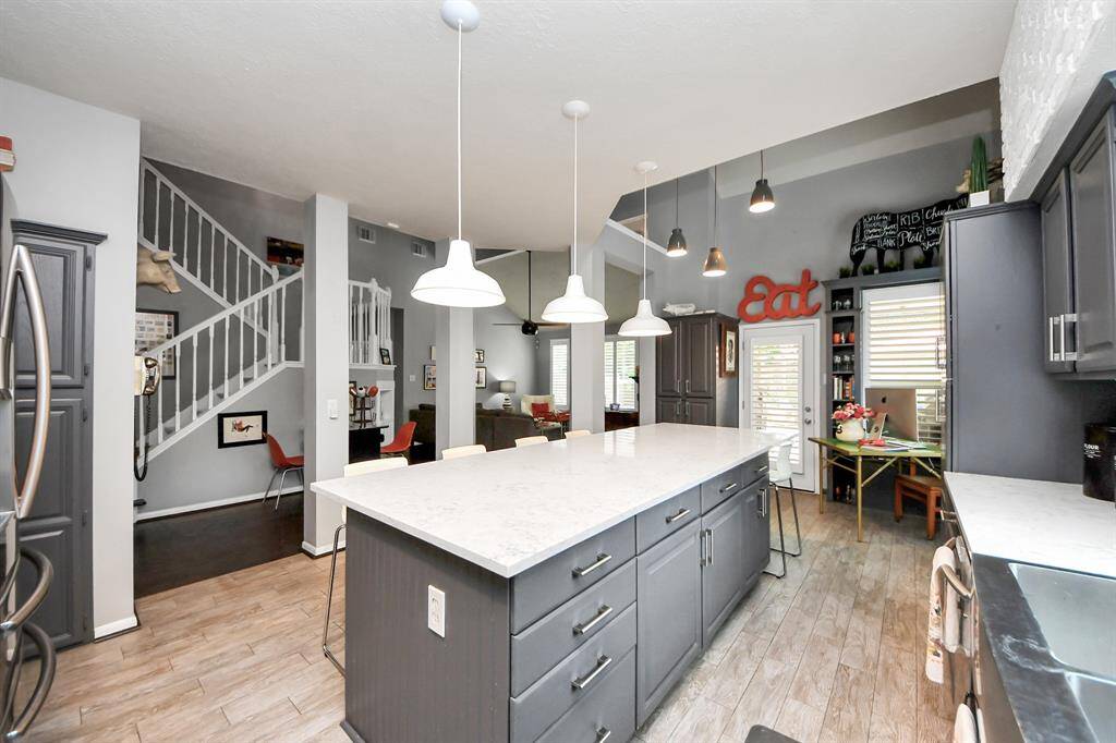 Enjoy seamless flow from the kitchen to the living areas in this open-concept layout. The expansive center island offers abundant prep space and casual seating