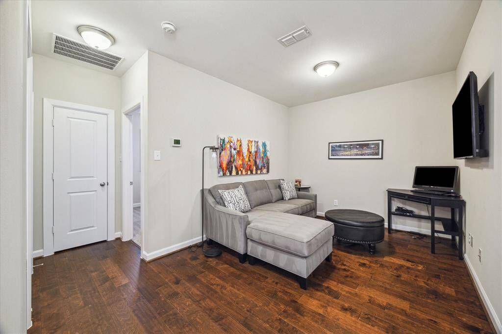 Versatile upstairs loft offers the perfect flex space—ideal for a cozy second living area, playroom, or home office setup.
