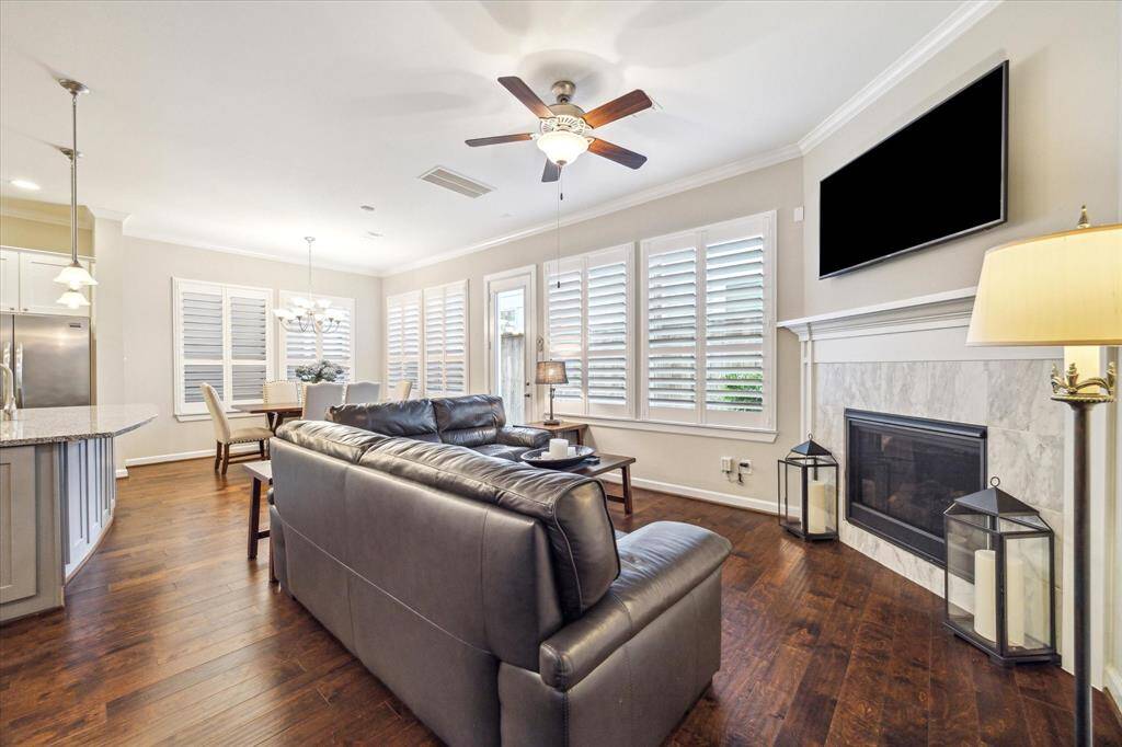 An open-concept layout blends comfort and style—enjoy relaxing in this spacious living room with seamless flow into the kitchen and dining areas.
