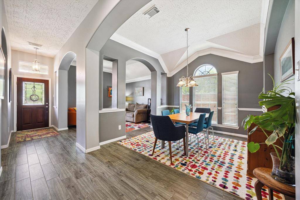 The formal dining area is filled with natural light and enhanced by elegant architectural details.