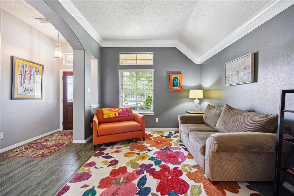 A spacious formal living room at the front of the home offers endless possibilities for living, play, or work.