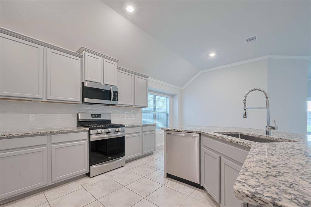 Granite counter tops and modern upgraded cabinetry with crown molding