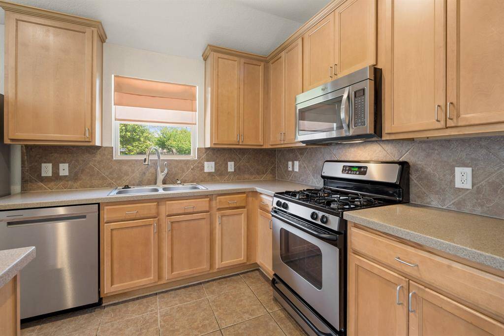 Tall cabinets and Corian countertops provide a sleek feel to the kitchen.