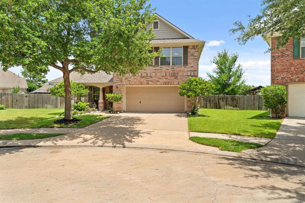 Well-maintained lawn and mature trees, offering shade and curb appeal.