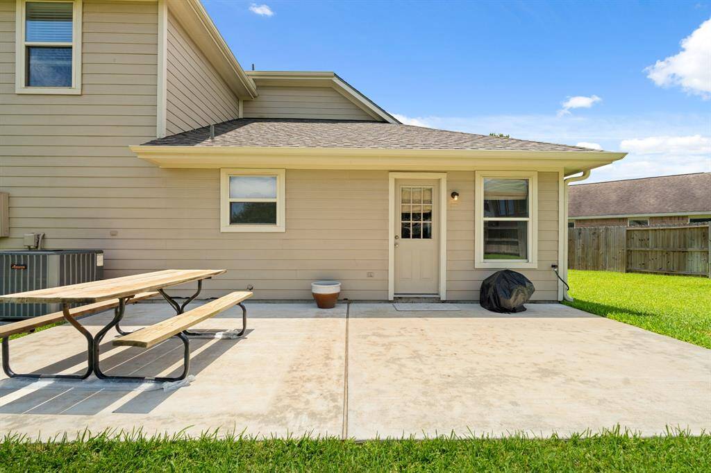 Huge backyard area with a concrete patio offering a great space for outdoor activities and relaxation.