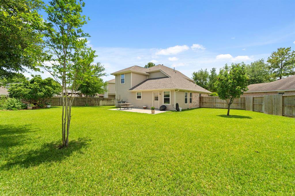 The house features a light exterior and a fenced perimeter for privacy. Perfect for outdoor activities and relaxation.