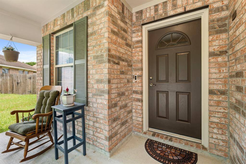 Front porch features a brick exterior, creating a charming entryway and providing a cozy and welcoming atmosphere.