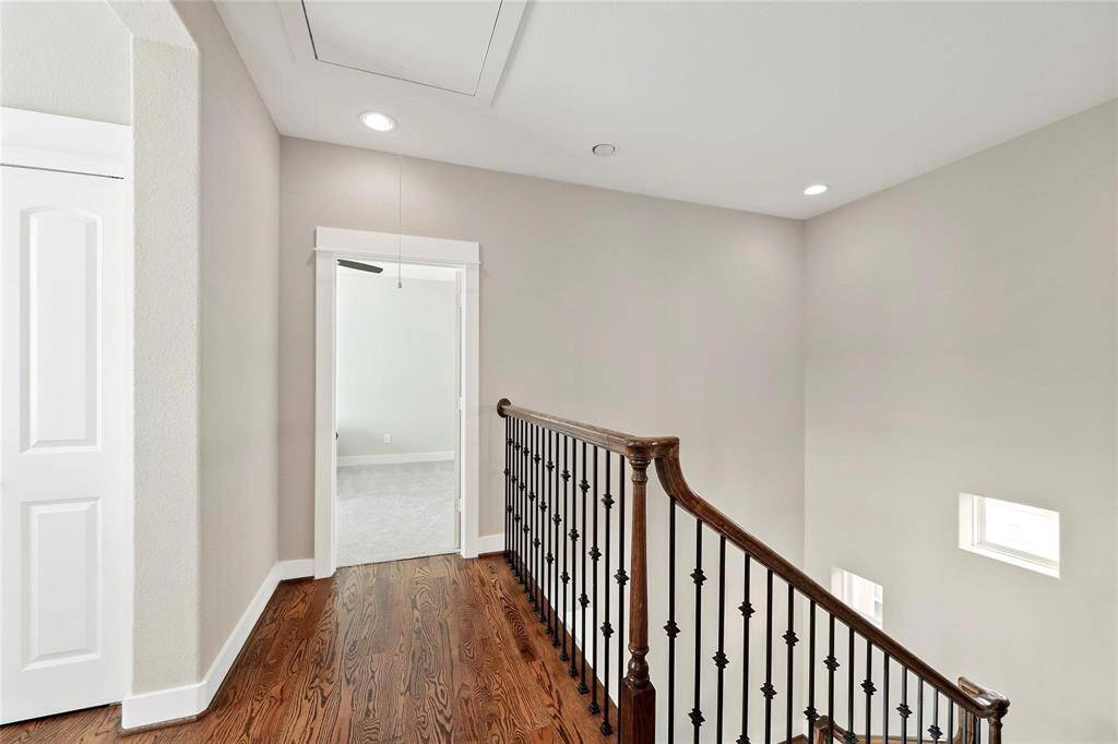 Third floor landing with hardwood floors.  The laundry room is on this floor between the two bedrooms.