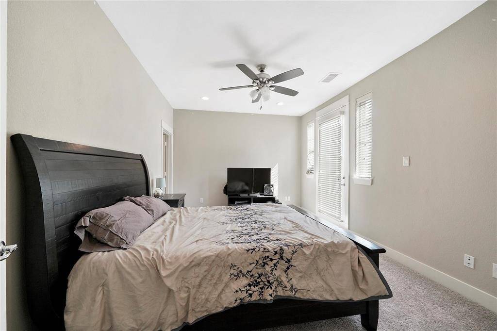 Primary bedroom with comfy carpet, walk-in closet and french doors open onto the private balcony.  Imagine morning coffee or a late night drink with someone special.