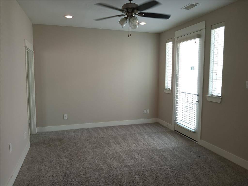 Primary bedroom with private balcony.  Adjoining is a private bath and walk-in closet.