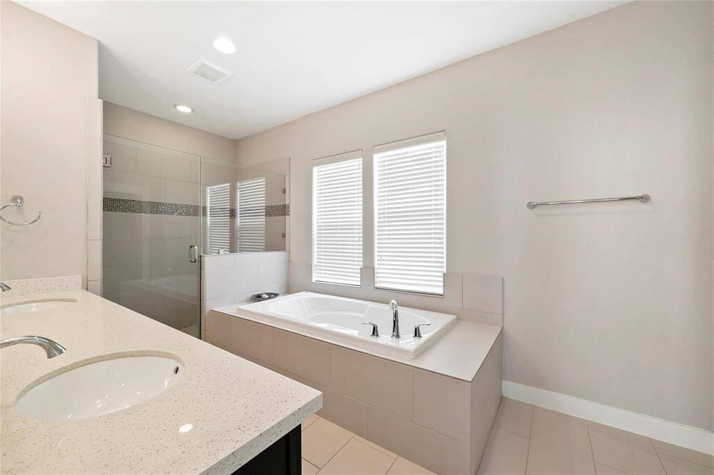 Primary bath with double sinks, large soaking tub and huge glass enclosed shower.