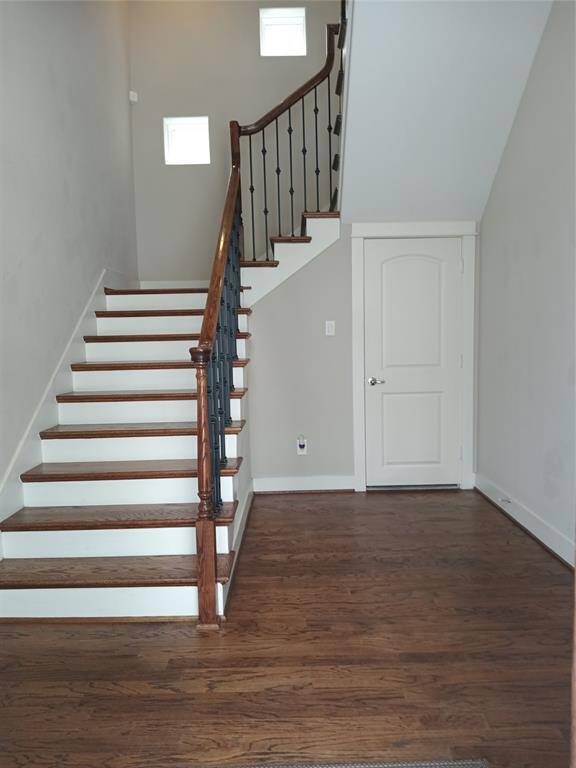 Open the front door into the foyer with hardwood floors and tall ceiling. Door opens into storage under the staircase.  Would you put a bench here to slip your shoes on or maybe a chest/bookcase for a place to drop your bag and keys.