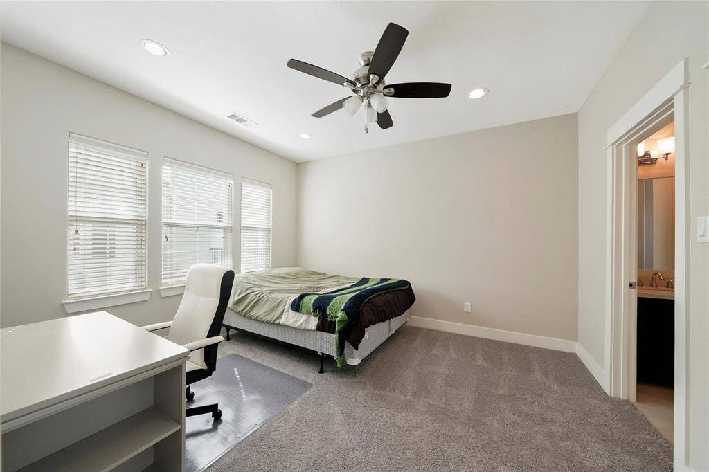 Staged.  Additional bedroom on the third floor with many windows for natural light, comfy carpet and private bath.
