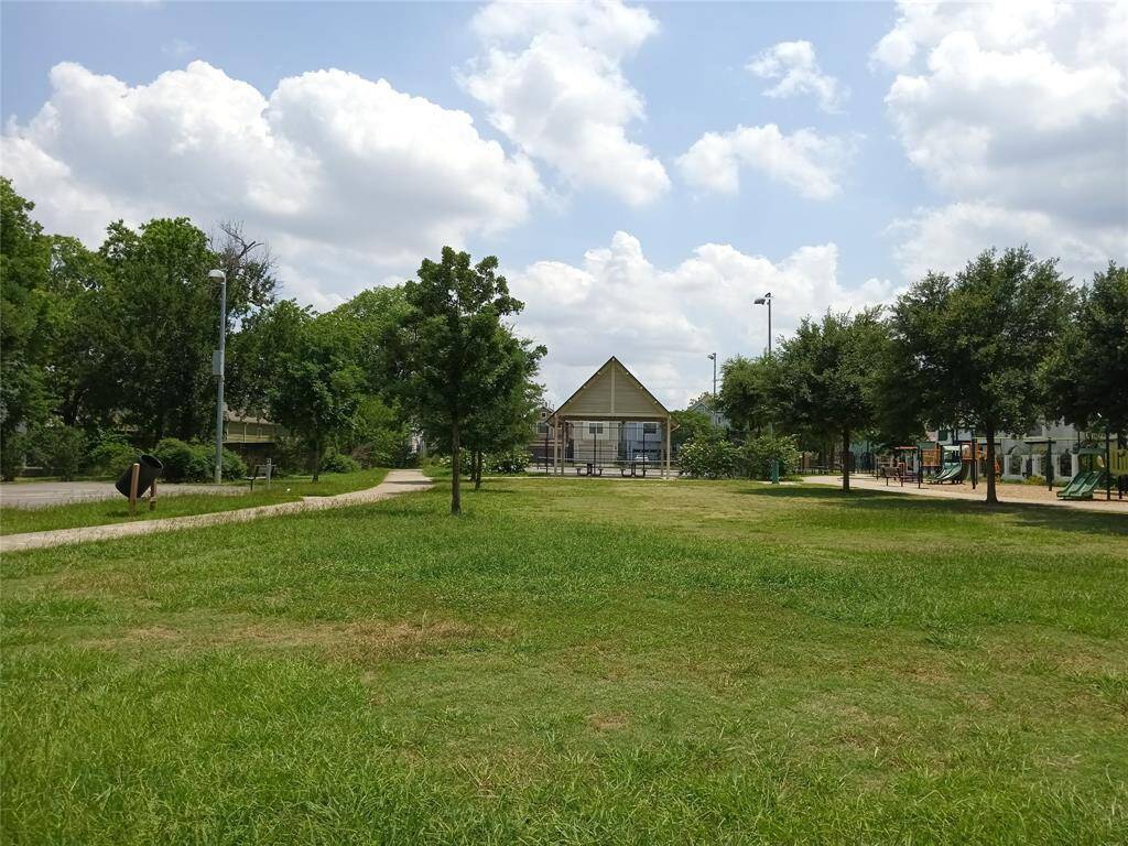 Another photo of the neighborhood park which goes through to W. 22nd Street.  Covered picnic table area is shown.  Walk two more blocks and your are at the neighborhood HEB grocery store.