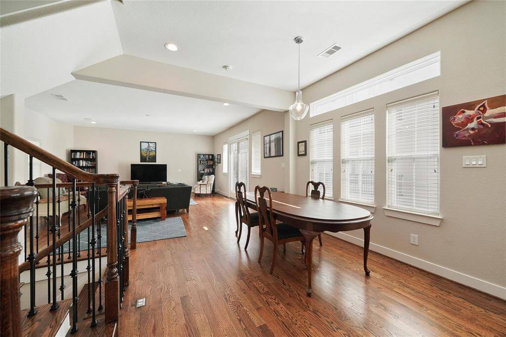 Dining room is in between the living room and island kitchen.  Beautiful hardwood floors and three windows fill the area with natural light.