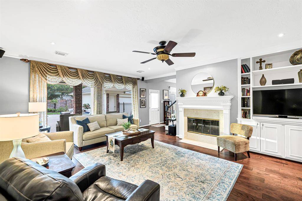 AUTHENTIC HARDWOOD FLOORS ADORN THE LIVING SPACES HIGHLIGHTED BY CUSTOM CABINETRY