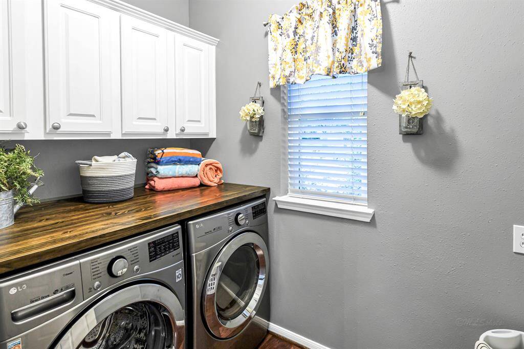 LARGE LAUNDRY ROOM W/LG WASHER AND DRYER THAT CONVEY TO THE PROUD NEW OWNERS