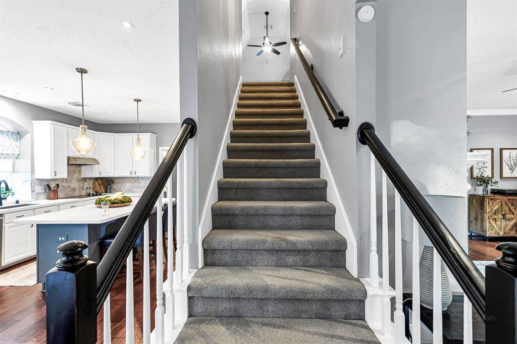 BACK STAIRCASE FROM KITCHEN LEADS TO FULLY REMODELED UPSTAIRS THREE BEDROOMS, TWO BATHS, AND GAME ROOM
