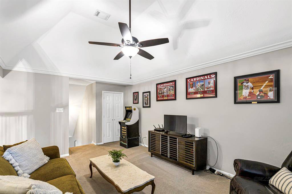 VIEW OF GAME ROOM LOOKING INTO STAIRWAY ENTRANCE WITH SPACIOUS GAME CLOSET