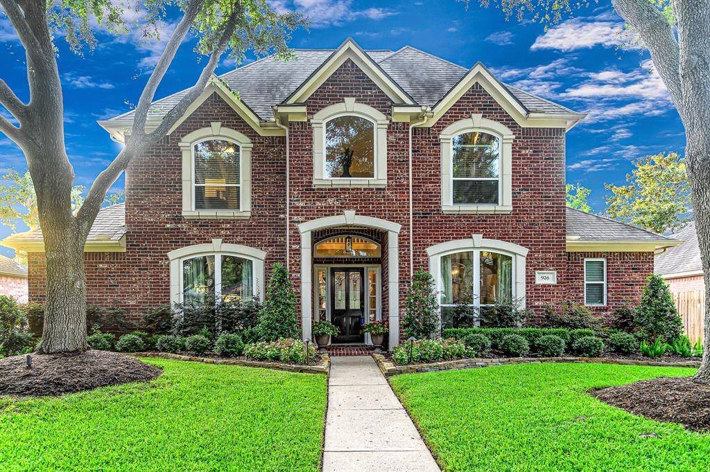 MATURE TREES AND PROFESSIONAL LANDSCAPING FRAME THIS NEW TERRITORY STUNNER!