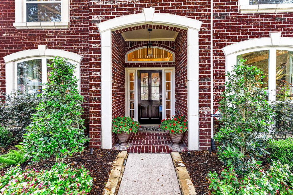STONE FRAMING ON GORGEOUS FRONT DOOR AND WINDOWS ARE ONE OF THE MANY UPGRADES THIS HOME HAS TO OFFER