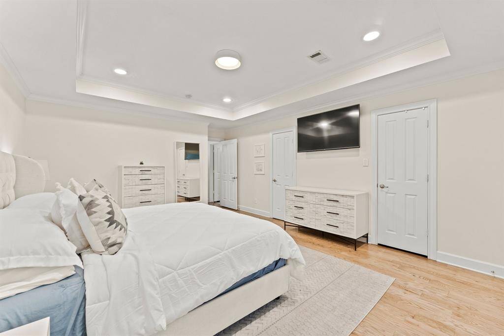 Primary bedroom with en-suite bathroom and separate walk-in closet at the end of first floor main hallway.