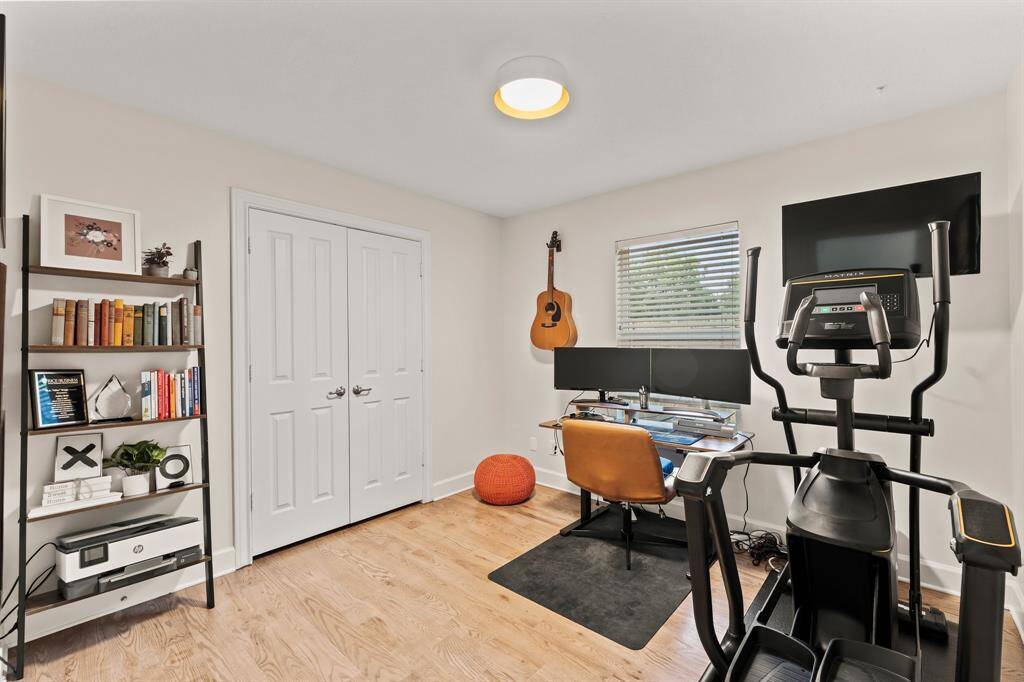 Secondary bedroom on first floor currently utilized as work-out room and office.