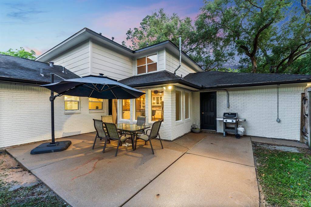Back yard patio with side access from garage as well as gated access to driveway.
