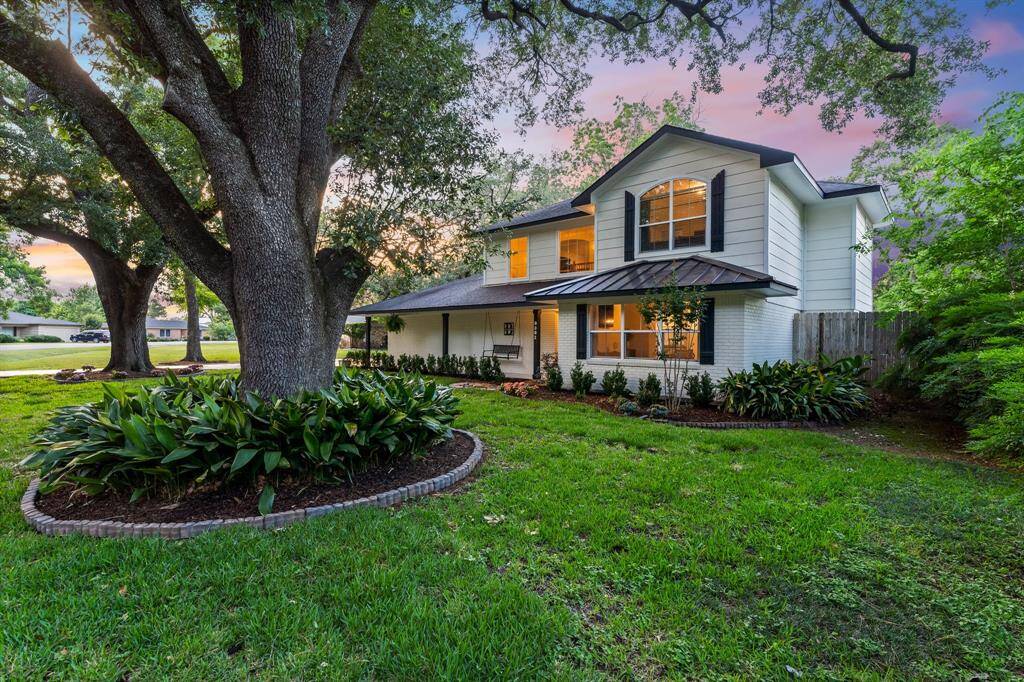 Pair of mature oaks frame this gorgeous 4 bedroom.