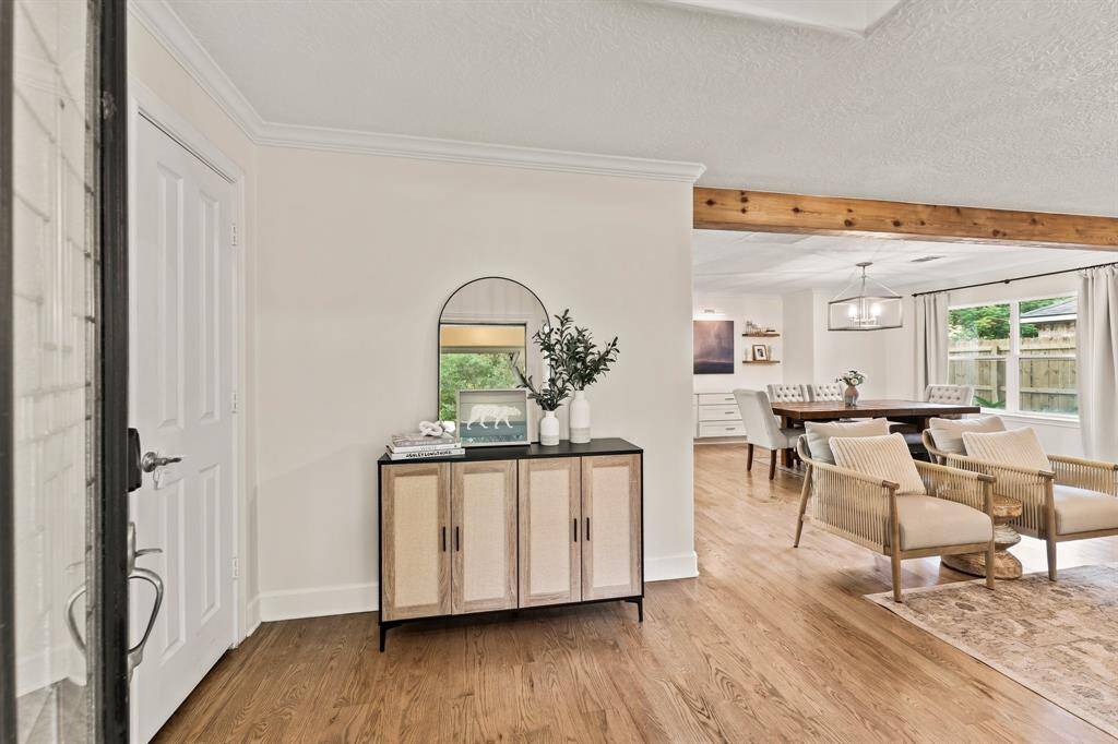 Welcoming foyer with beam accent and walk-in closet.