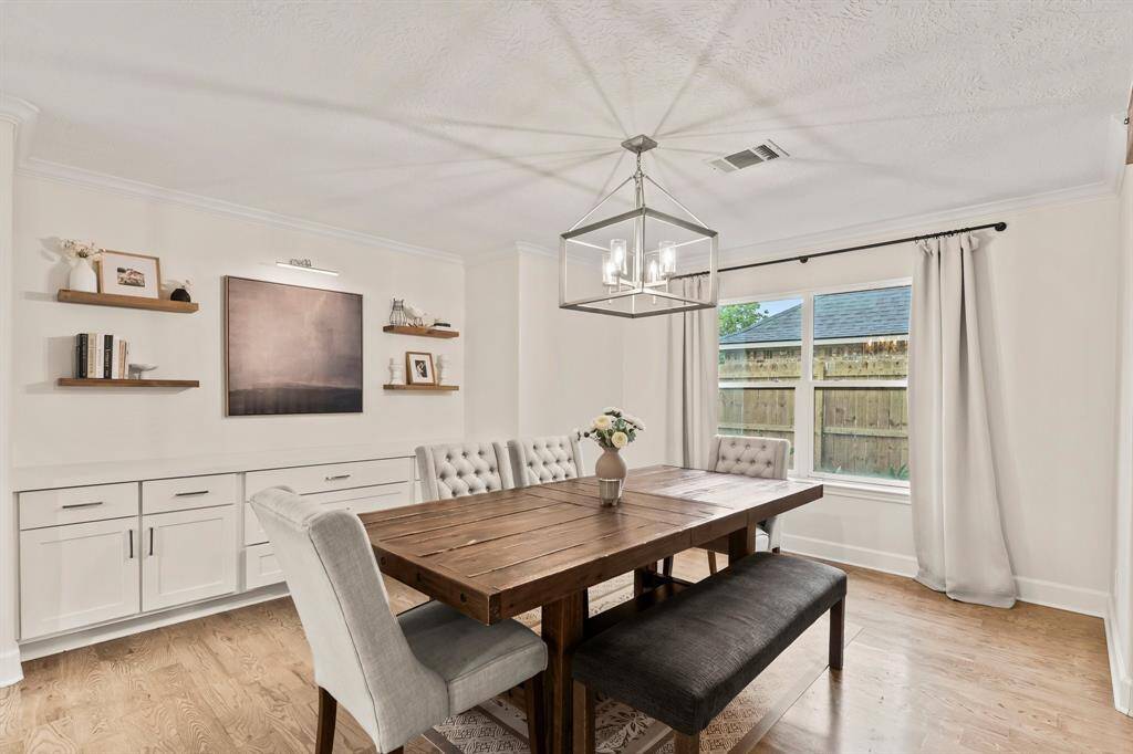 Dining room with chandelier and upgraded built-in buffet storage.