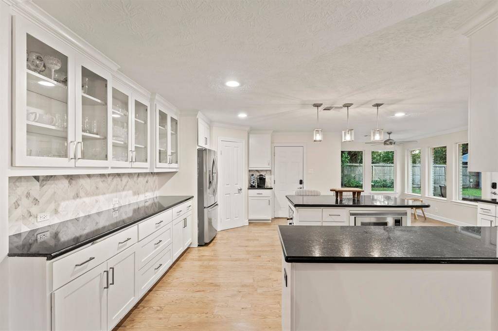 impressive kitchen space with tons of storage!  Recessed lighting, walk-in pantry, built in microwave, and coffee bar.