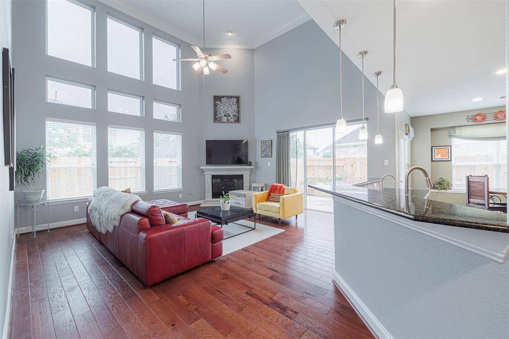 . Spacious family room features soaring ceilings, gaslog fireplace & a wall of windows overlooking the backyard.