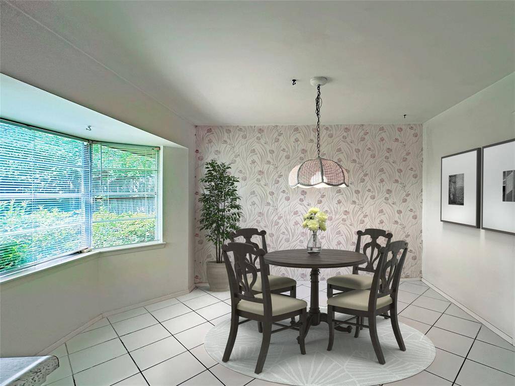 This breakfast room features a cozy dining area with a large bay window. The Large Bay windows offer plenty of natural light, and the white tiled floor adds a clean, spacious feel. Image Virtually Staged.