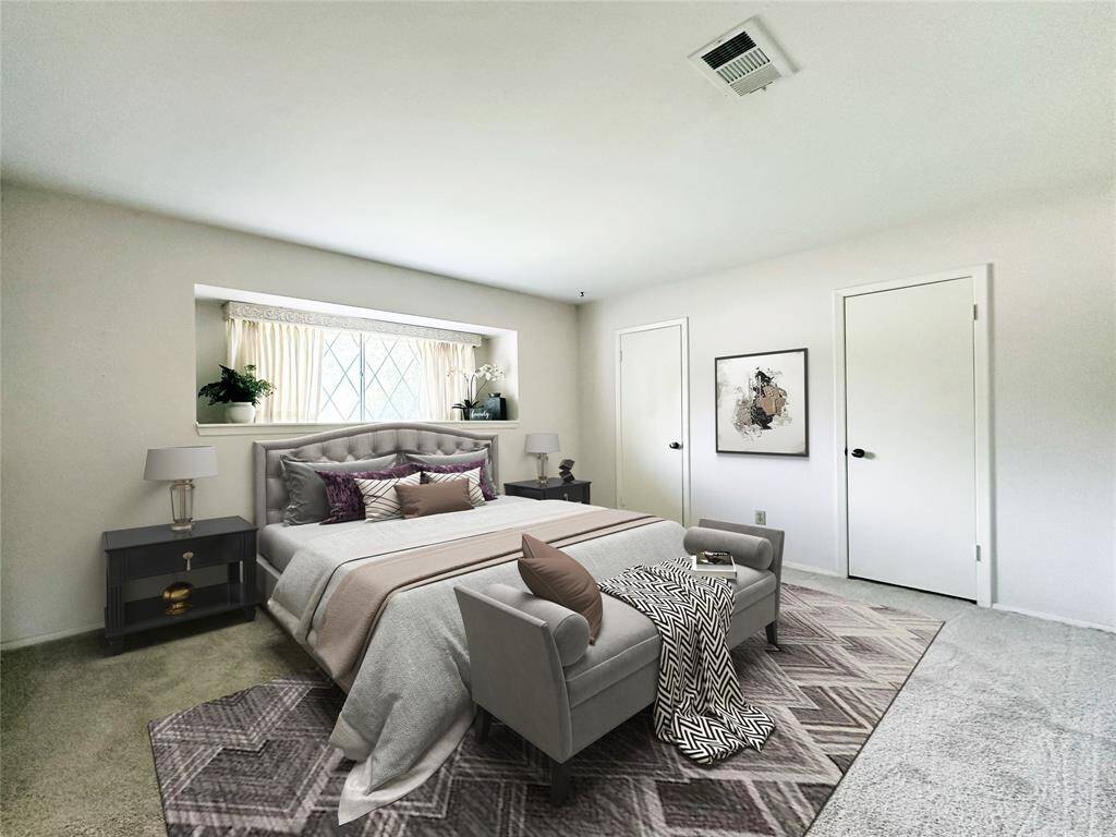 Primary Bedroom has fresh carpet.  A large window with display shelf offers lots of natural light.  A closet encompasses the entire wall with 2 doors for entry and easy access. Image is Virtually Staged.