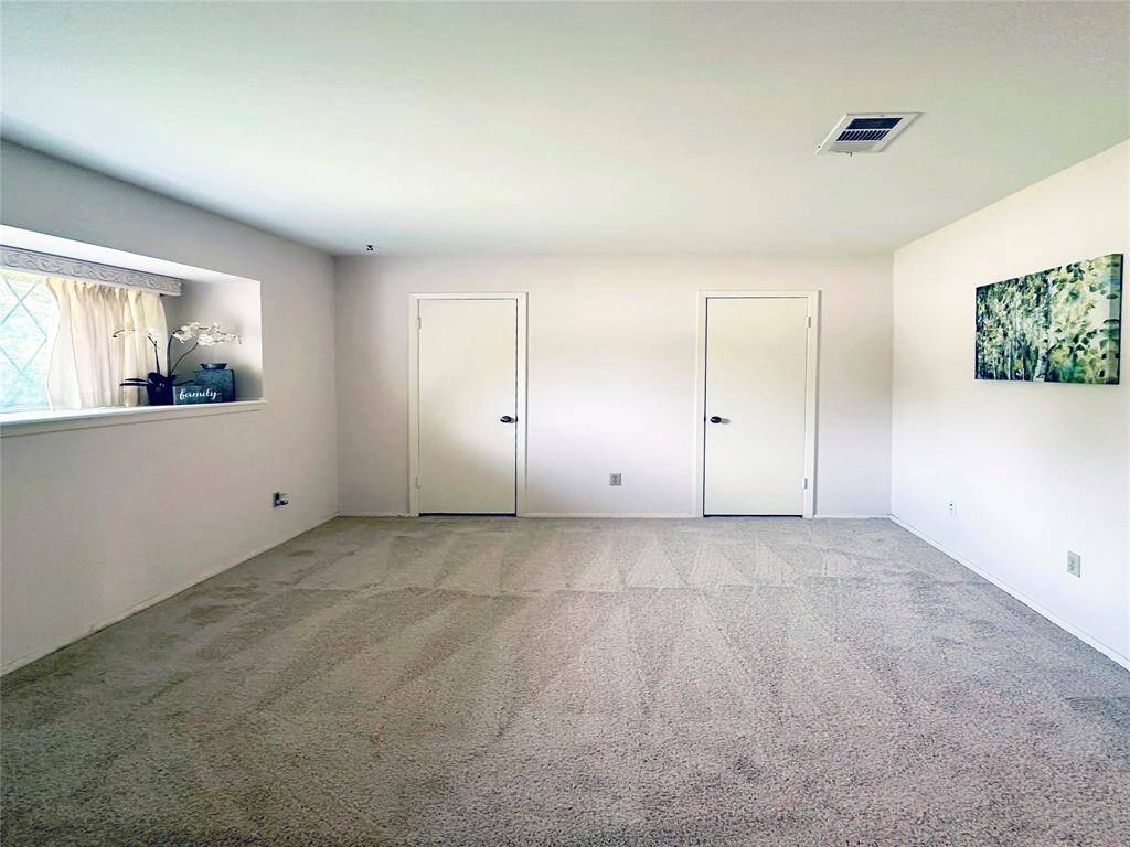 Primary Bedroom has fresh carpet.  A large window with display shelf offers lots of natural light.  A closet encompasses the entire wall with 2 doors for entry and easy access.