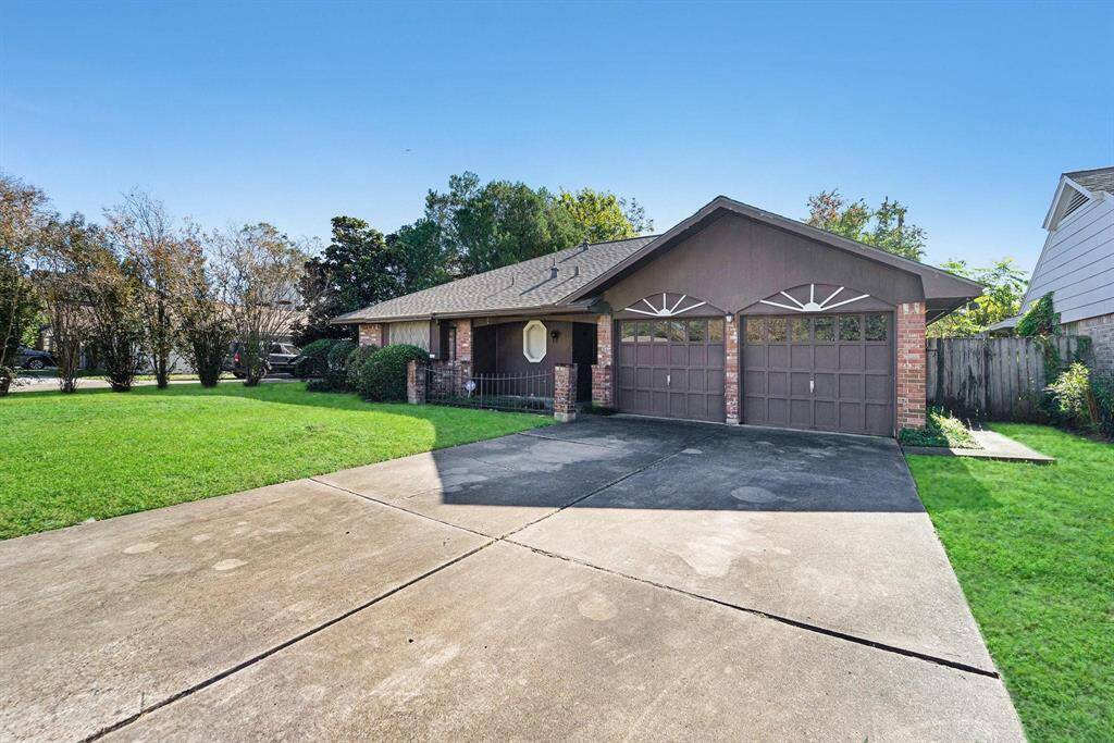 Charming single-story home with a spacious front yard and double garage. It features a brick exterior, a wide driveway, set in a desirable Tanglewilde Subdivision