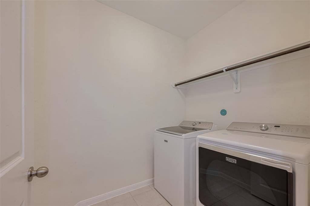 The 5'2" x 9'4" utility room is designed for convenience and efficiency. It features tile flooring for durability and easy maintenance, along with both electric and gas dryer connections to suit your appliance needs. A Maytag washer and dryer set is included, making laundry tasks simple and streamlined.