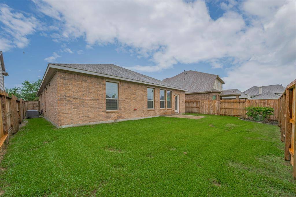 The backyard is enclosed with a privacy fence, offering seclusion and security. A side gate door provides convenient access to and from the yard.
