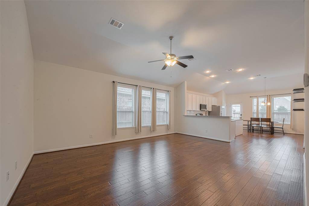 Spanning 16' x 20', this spacious family room is filled with natural light from large windows that frame the space beautifully. A ceiling fan with a light kit provides both comfort and illumination. The room features fresh interior paint (2025), offering a clean, updated look that complements any décor style.