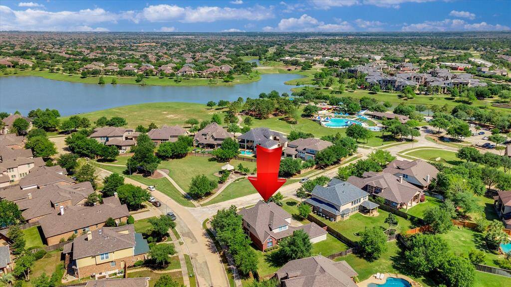 Spacious suburban home in a picturesque neighborhood, featuring tree-lined streets and a nearby lake. The community includes a pool and offers a serene, family-friendly environment.