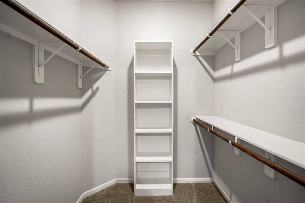 Closet goals, achieved. This walk-in closet features multi-leveled hanging space, built-in shelving for shoes or accessories, and room to grow. Whether you’re a minimalist or a full-on wardrobe warrior, there’s a place for everything—and it’s all tucked neatly off the primary suite for convenience.