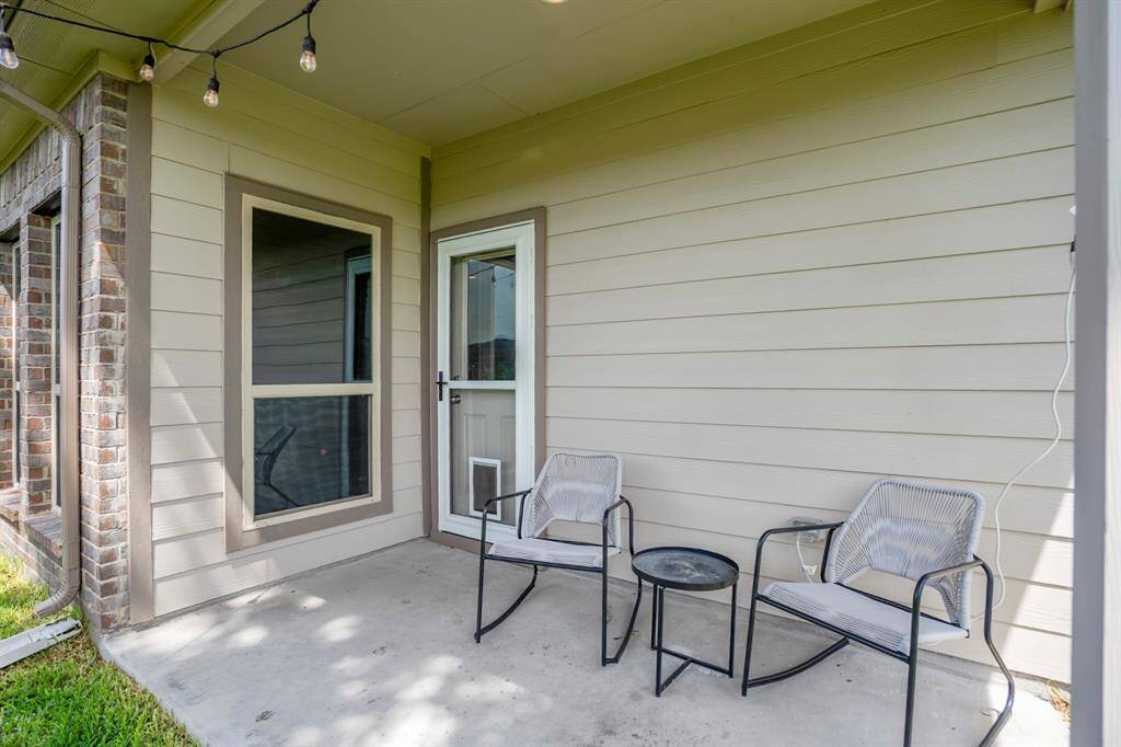Whether you're sipping coffee at sunrise or winding down under the string lights, this covered patio is ready for it. Bonus: the storm door with built-in pet access makes it easy for your furry companions to enjoy the yard too—no human assistance required.