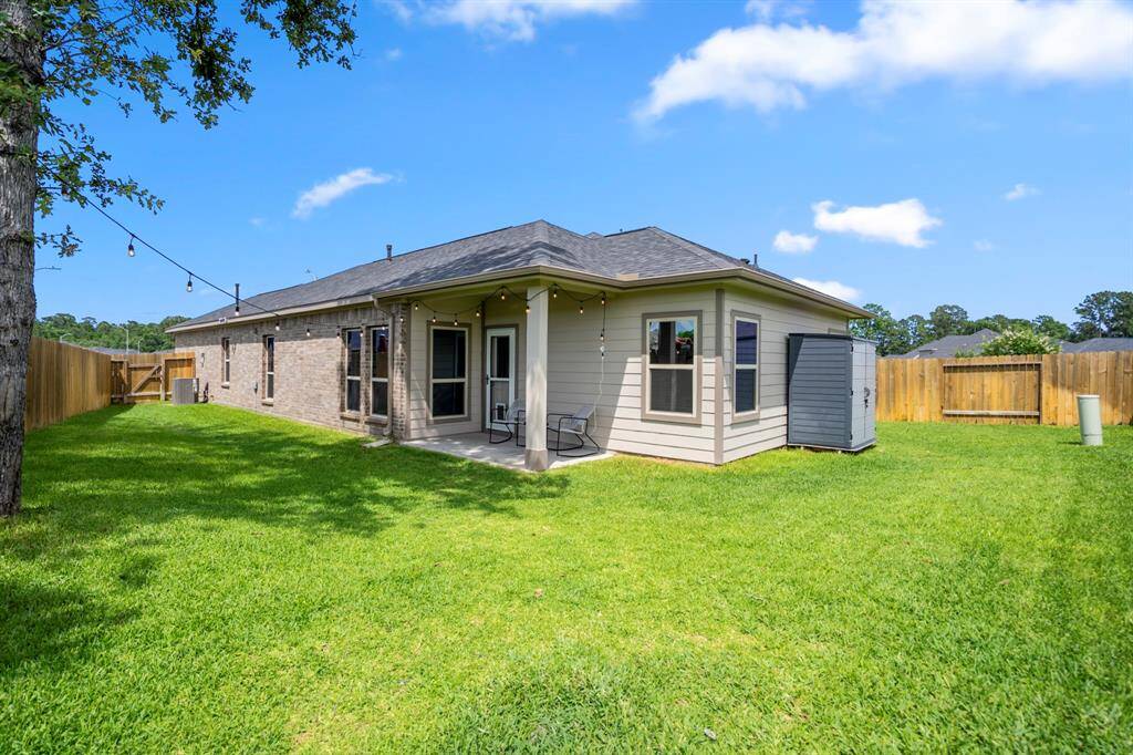 This backyard hits the sweet spot—spacious and versatile with mature trees, a covered patio for lounging, gutters already installed, and that soft start A/C unit quietly doing its thing in the background. Bonus points for the side-yard gate and proximity to the neighborhood park—just over the fence to the left!