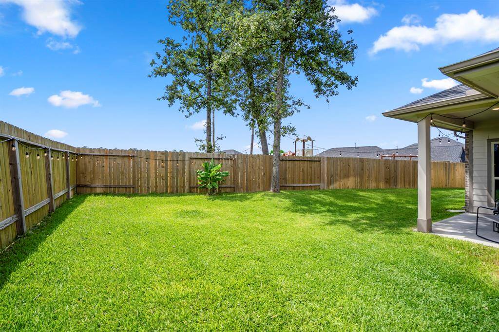 The fence along the back corner of the yard actually borders the neighborhood park—talk about easy access to fun just a few steps away. Plus, those mature trees? A rare treat in newer communities like this one.