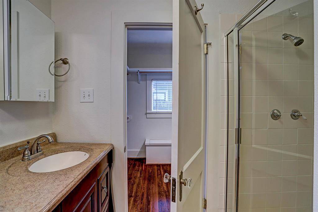 [Bathroom 1] The en-suite bathroom attached to the primary offers plenty of countertop space, as well as a walk-in shower.