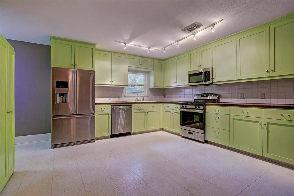 [Kitchen] The kitchen offers an abundance of space for cooking, and features solid surface concrete countertops.