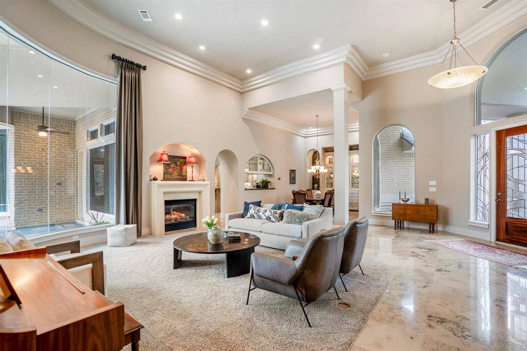 High ceilings and clean-lined moldings accentuate the elegant modern style, complemented by gorgeous natural marble tile flooring.