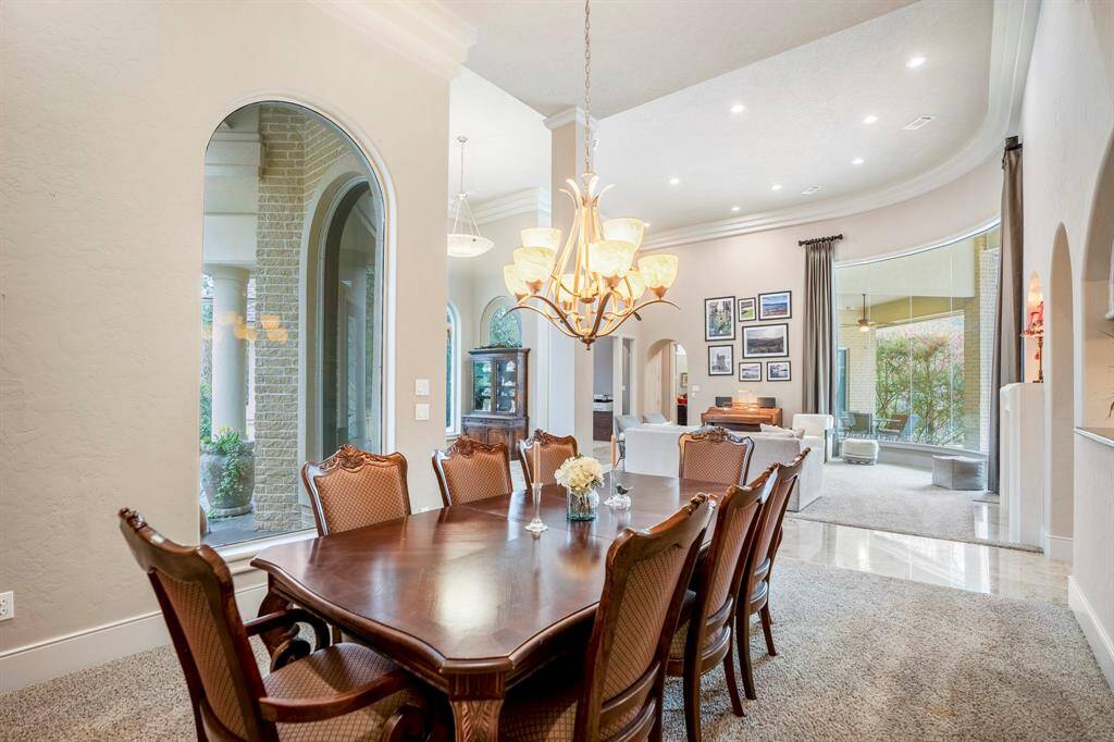 The formal dining room is ideal for entertaining, offering an easy flow to both the living room and kitchen, including a pass-through granite serving counter.