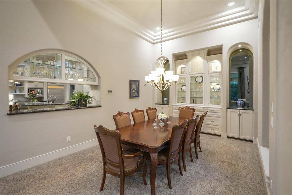 Elegant built-in designer showcase cabinetry, perfect for displaying your finest pieces adds a touch of sophistication to your gatherings.